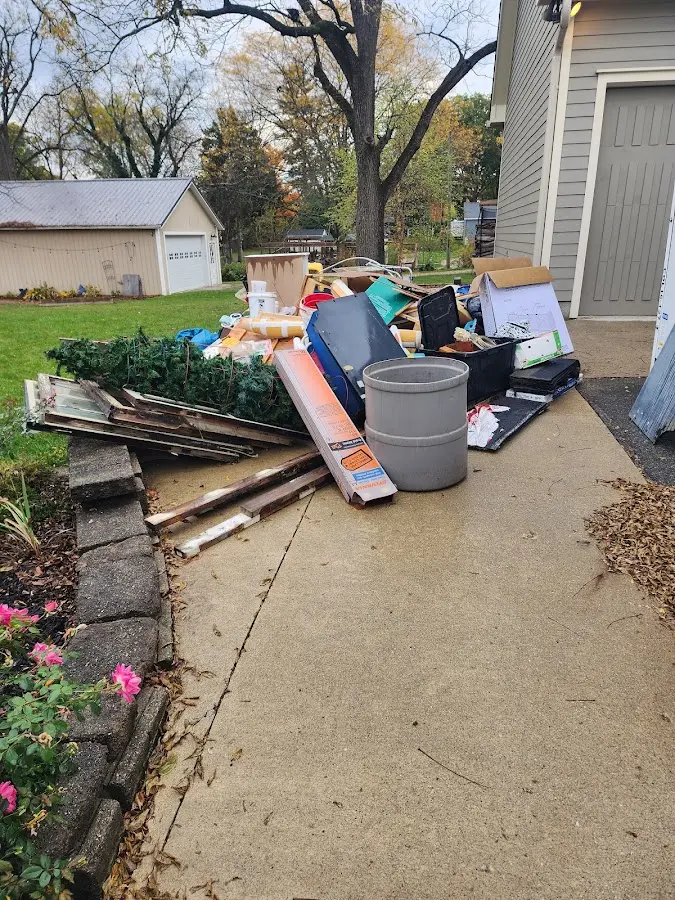 Dumpster being loaded with debris for 12 Yard Dumpster Rental in Meridian